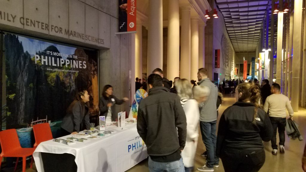 <photo> PDOT-San Francisco team Alessa Lopez and Nadine Tanjuakio engaging event goers to spin the wheel for promotional giveaways and answering inquiries about Philippine destinations.